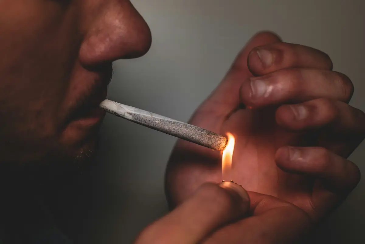 Hemp flower being smoked, triggering THCA to THC conversion